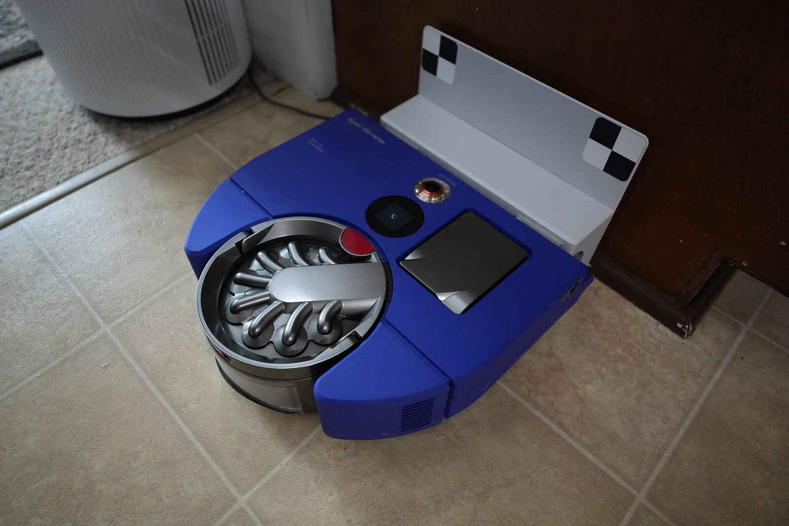 Dyson 360 Vis Nav robot vacuum on hardwood in a real home with three cats