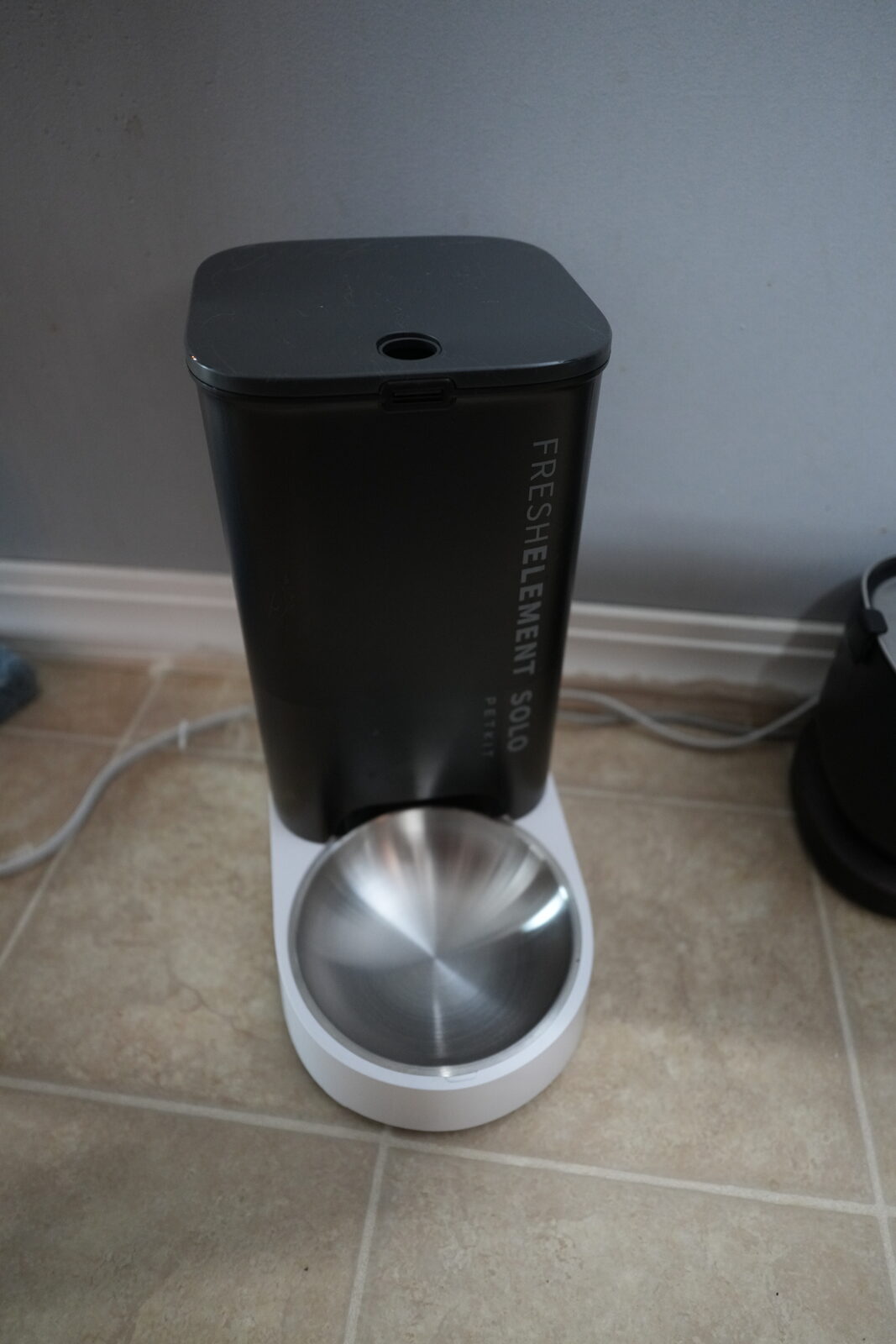 Petkit FreshElement Solo automatic cat feeder with stainless steel removable bowl on tile floor in a three-cat home