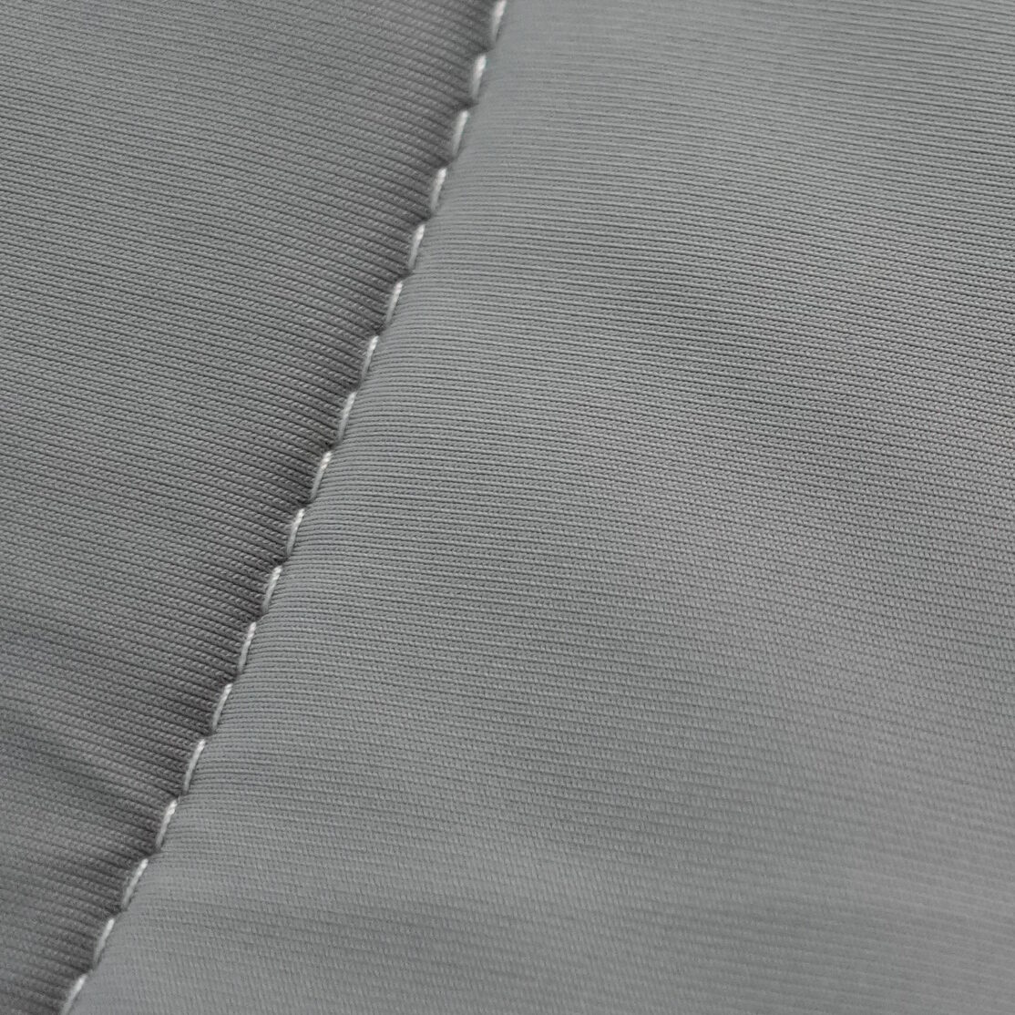 Macro close-up of REST Evercool+ nylon sheet showing a tight, smooth, ribbed weave